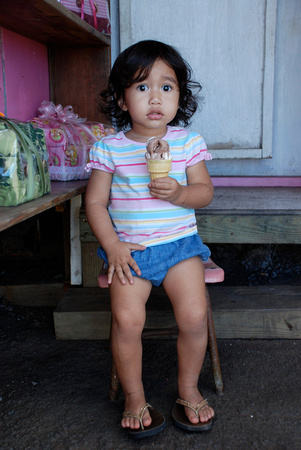Little girl at her parents fruit stand on Maui